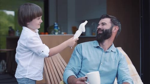 Son Showing Toy to Father Little Boy Ripping Head of Favorite Fiction Character Handsome Dad Looking