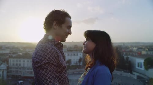 In Front of a Balcony Overlooking the City a Happy, Italian Couple