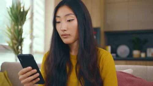 Young Woman Using Smartphone in Modern Home