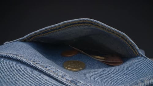 Close-up view of jeans texture. Money left in the pocket. Probe lens, background.
