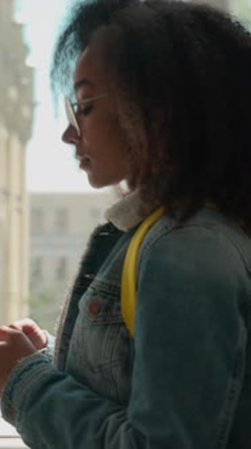 Side View African American Female Student Walk University Corridor Mobile Phone Using Smartphone