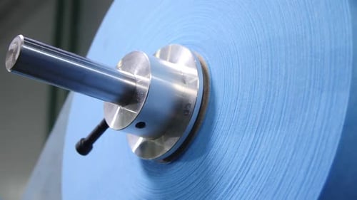 Blue Fabric Roll for Protective Masks on Metal Rod at Plant
