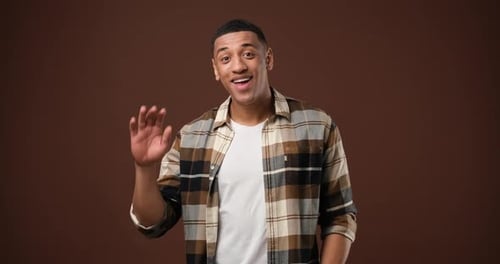 Young Adult Smiling and Waving Hello