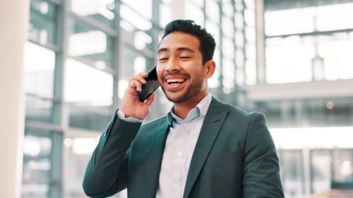 Young Man Talking on Cell Phone in Office