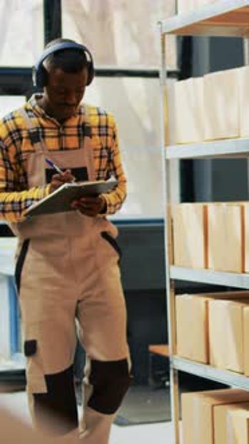 Vertical Video Storage Room Employee Dancing and Listening to Music