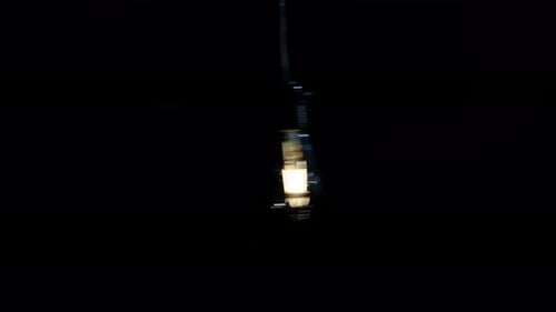 Vintage Edison Bulb Flickering in Dark Room CloseUp