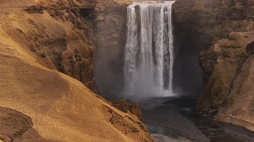 Waterfall cascading over cliffs at Skógafoss in Iceland, an iconic natural wonder in the landscape