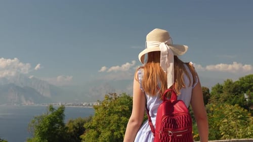 Woman with Hat Overlooking Tropical Ocean Landscape