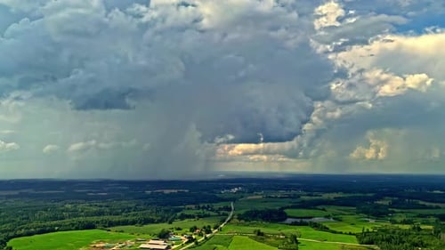 Stormy Cloudscape Over Green Plain Meadows In Countryside Town. Timelapse