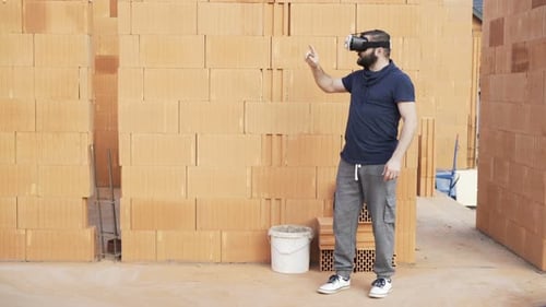 Man uses VR headset in building under construction