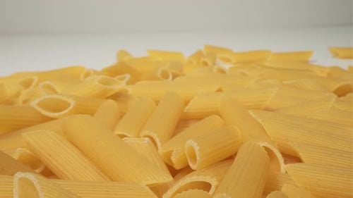 Close Up of Uncooked Penne Rigate Pasta for Background Use Dry Macaroni Noodles with Space for Text