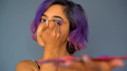 Young Woman Doing Colorful Eyeshadow Makeup Close Up 4K