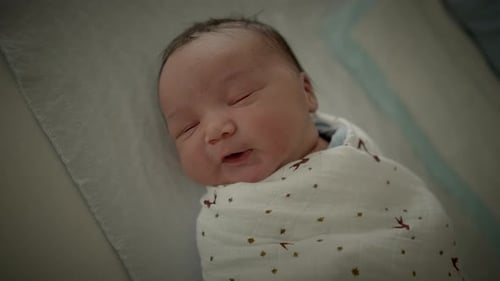 Infant Sleeping Peacefully in a Swaddling Blanket