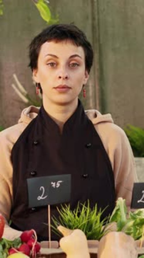Woman Standing Behind Fruit and Vegetable Market Stall