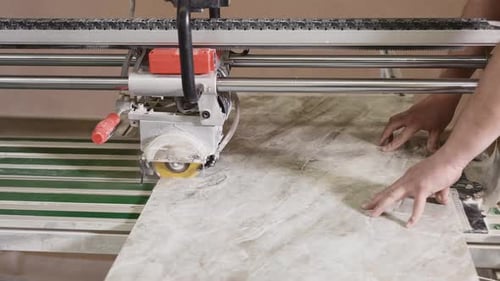 Worker Cuts Tile with Wet Circular Saw