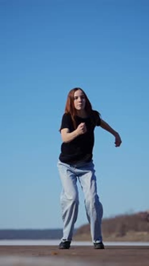 Teen Girl Dancing and Jumping Outside on Sunny Day