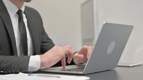 Close up of Businessman Typing on Laptop