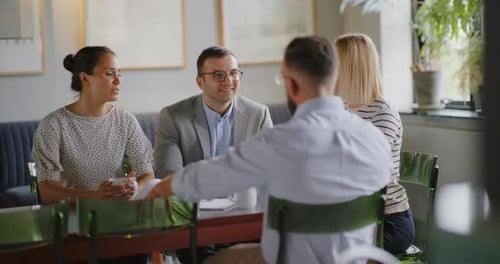 Business team meeting in modern office lounge for coffee break discussion