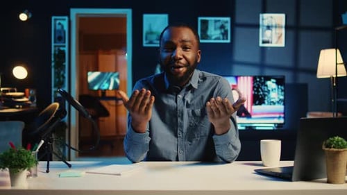 Friendly Man Speaking from Home Office Desk