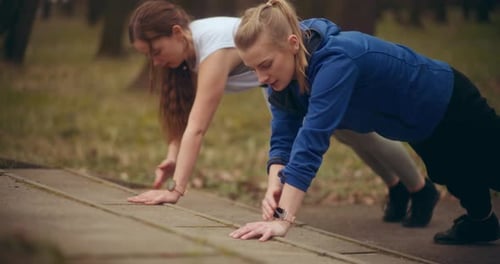 Sportswomen Practicing Warm Up Exercise in Garden