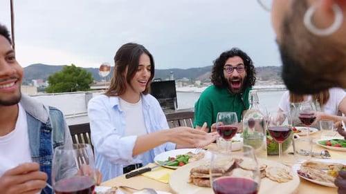 Happy Group of Friends Enjoying Dinner Barbecue in Summer at Home Terrace