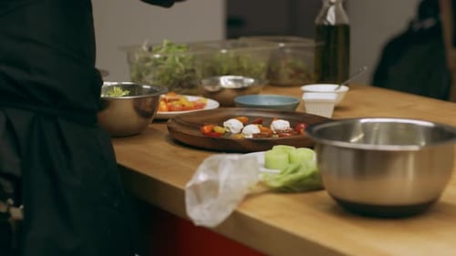 Chef Prepares Appetizing Tomato Salad in Restaurant Kitchen