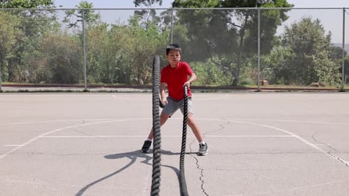 Boy Doing Battle Rope Exercise Outdoors