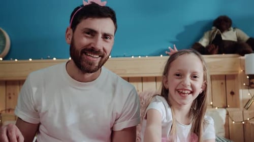 Father and Child Celebrating a Birthday on Bed