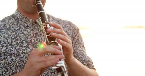 Man Musician Playing Classic Wind Instrument Clarinet Outdoor Sunlight