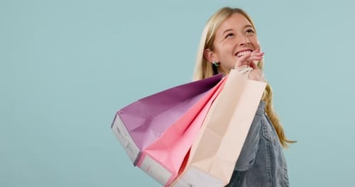 Fashion, face or happy woman with shopping bag from boutique sale or promotion on blue background