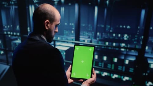 Network Engineer Doing System Check on Green Screen