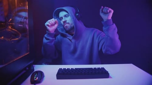 Man Dancing at His Computer at Night