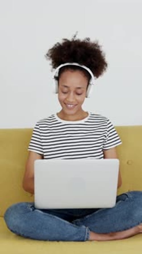 Teenage Girl Works on Laptop at Home Smiling