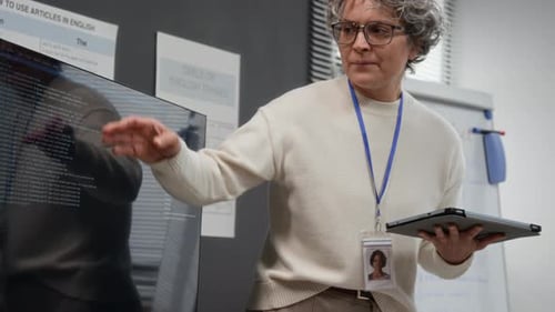 Female Teacher Explains Lesson with Interactive Whiteboard