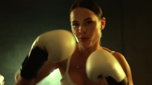 Intense Woman Boxing Training in Ring