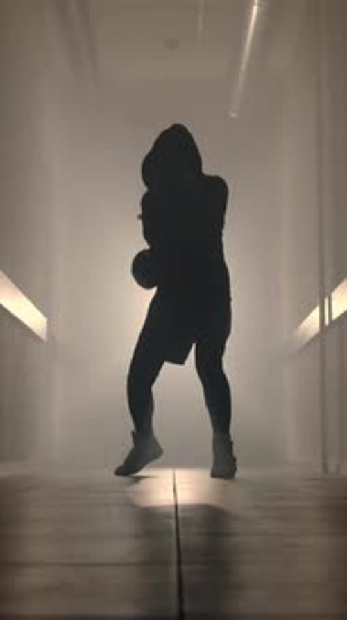 Boxer Training in Dark and Smoky Industrial Space