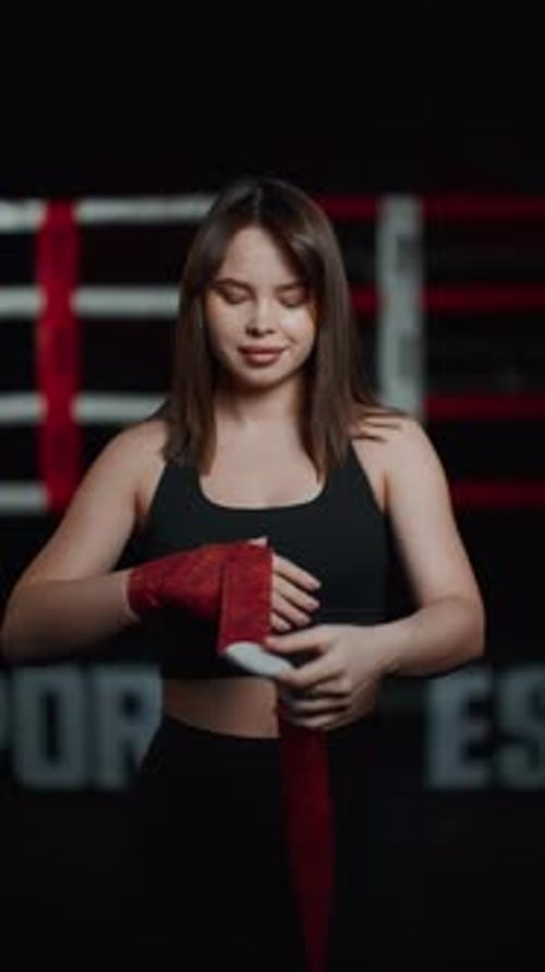 Young Woman Wrapping Hands for Boxing Workout