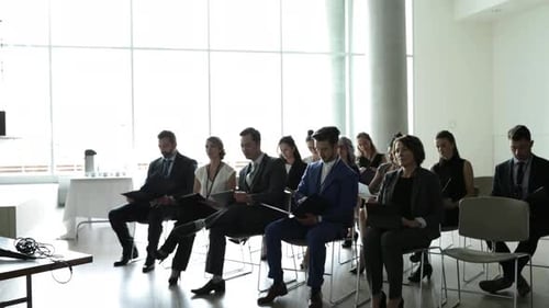 Business People Sitting in Conference Room Listening to Presentation
