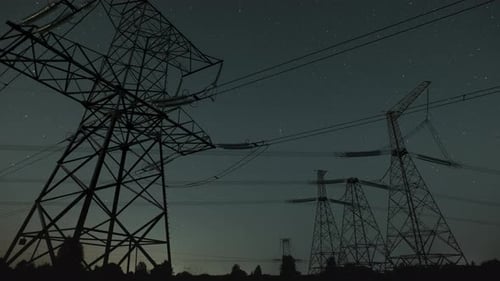 Power Line Towers Against Starry Night Sky