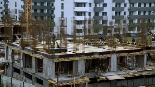 Construction Workers Building a Modern Condominium