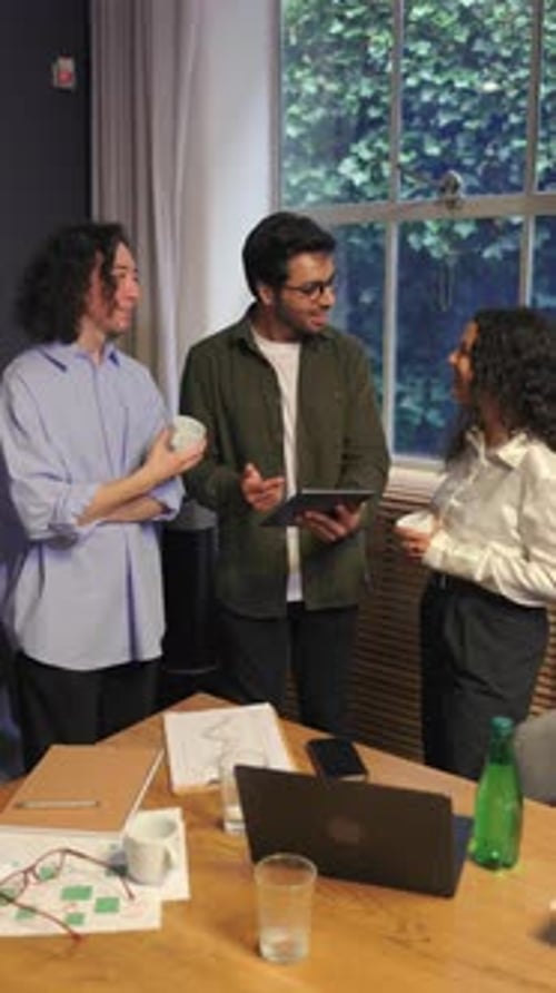 Diverse Business Team Collaborating Around Table in Bright Modern Office