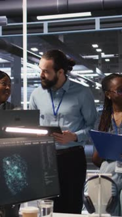 Professional Colleagues Discussing Technology in Modern Office