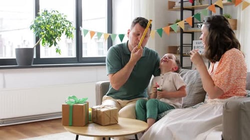 Happy Family Celebrates Birthday with Party Blowers
