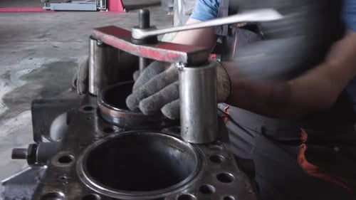 Mechanic Working on Car Engine in Repair Shop