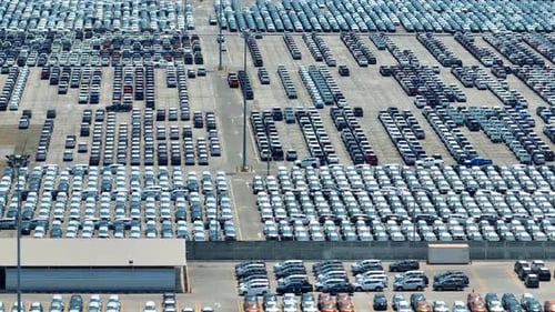 Aerial view of a parking lot full of cars in neat rows. 4K.