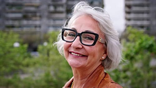 Portrait of a Healthy Happy Caucasian Senior Woman with Gray Hair Standing Outside at City