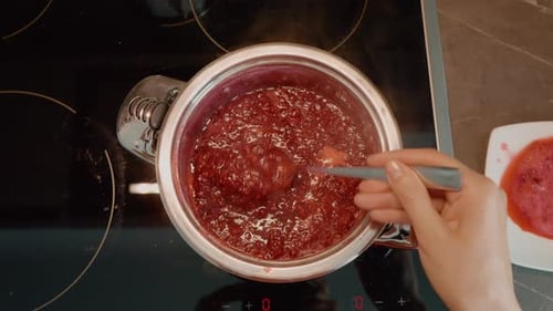 Cooking homemade raspberry jam in the kitchen from fresh ingredients