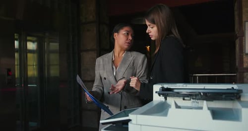 Businesswomen Review Document and Exchange Professional Opinions