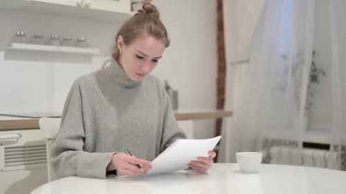 Woman with Papers Upset at Table