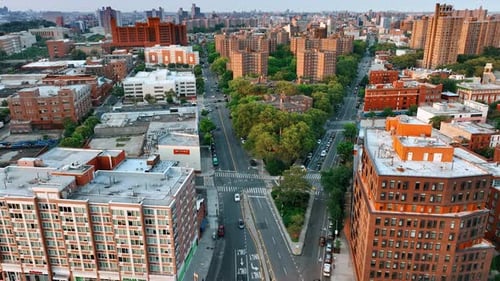 Two highways merge into one. Busy roads around the green residential area. New York cityscape
